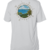 A white rash guard with an image of the ocean and palm trees.
