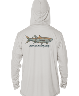 A man wearing a Grateful Angler Keys Tarpon UV Hoodie with an image of a shark on it.