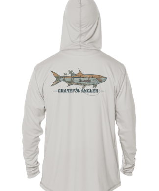 A man wearing a Grateful Angler Keys Tarpon UV Hoodie with an image of a shark on it.