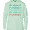 Light green UPF 50+ hoodie with "Pickleball" text in multiple colors, perfect for sun protection.