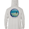 A white rash guard with an image of the ocean and a boat.