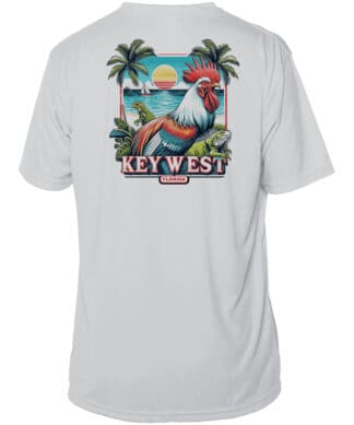 Bright wildlife-themed UPF 50+ sun shirt featuring a colorful rooster, palm trees, and ocean scene,.
