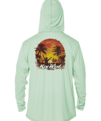 A green rash guard with a sunset and palm trees.