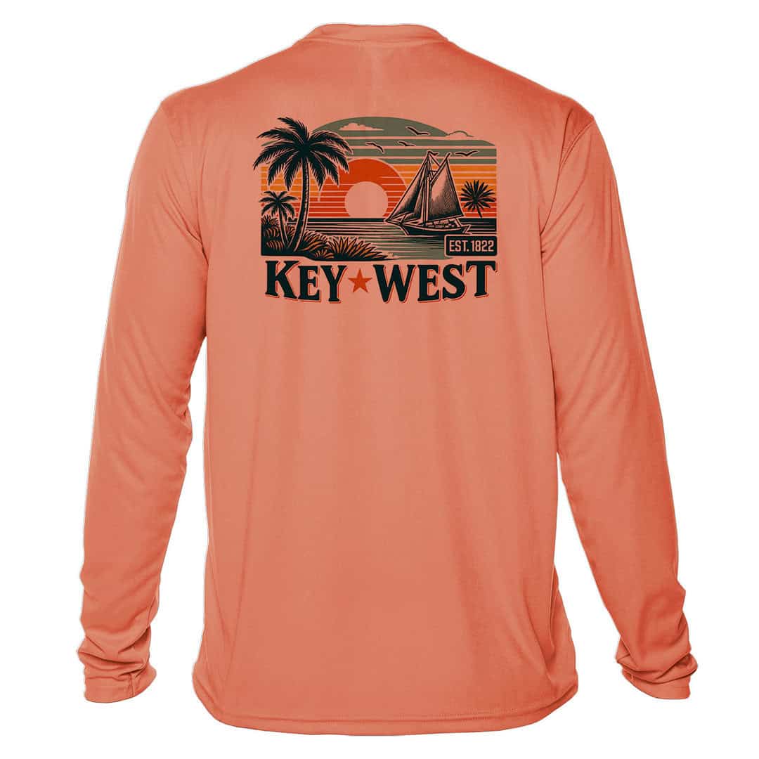 Bright salmon long sleeve UPF 50+ sun shirt with tropical sunset and sailboat graphic. Perfect for b.